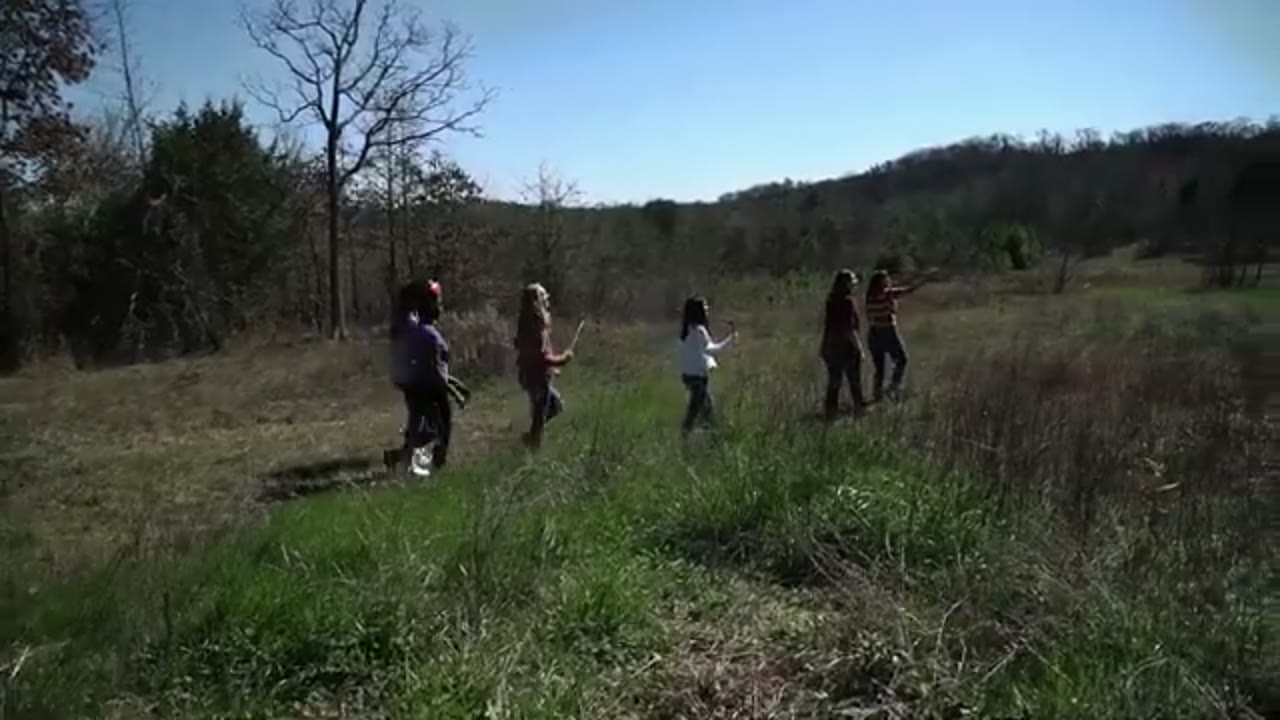 Girls running through a field at Gateway of Hope